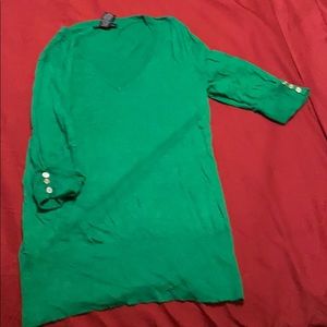 V neck top containing silver buttons on sleeves.